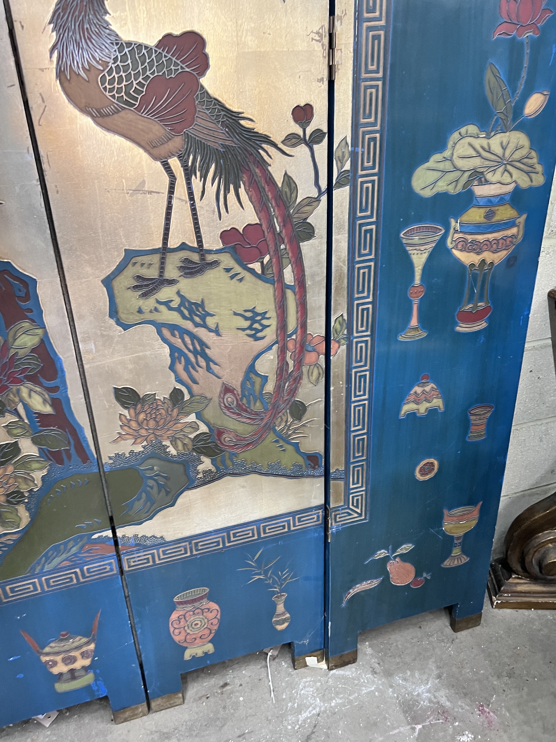 A Chinese lacquered eight fold screen decorated with exotic birds among flowering trees, each panel width 40cm, height 244cm (no fixing clips)